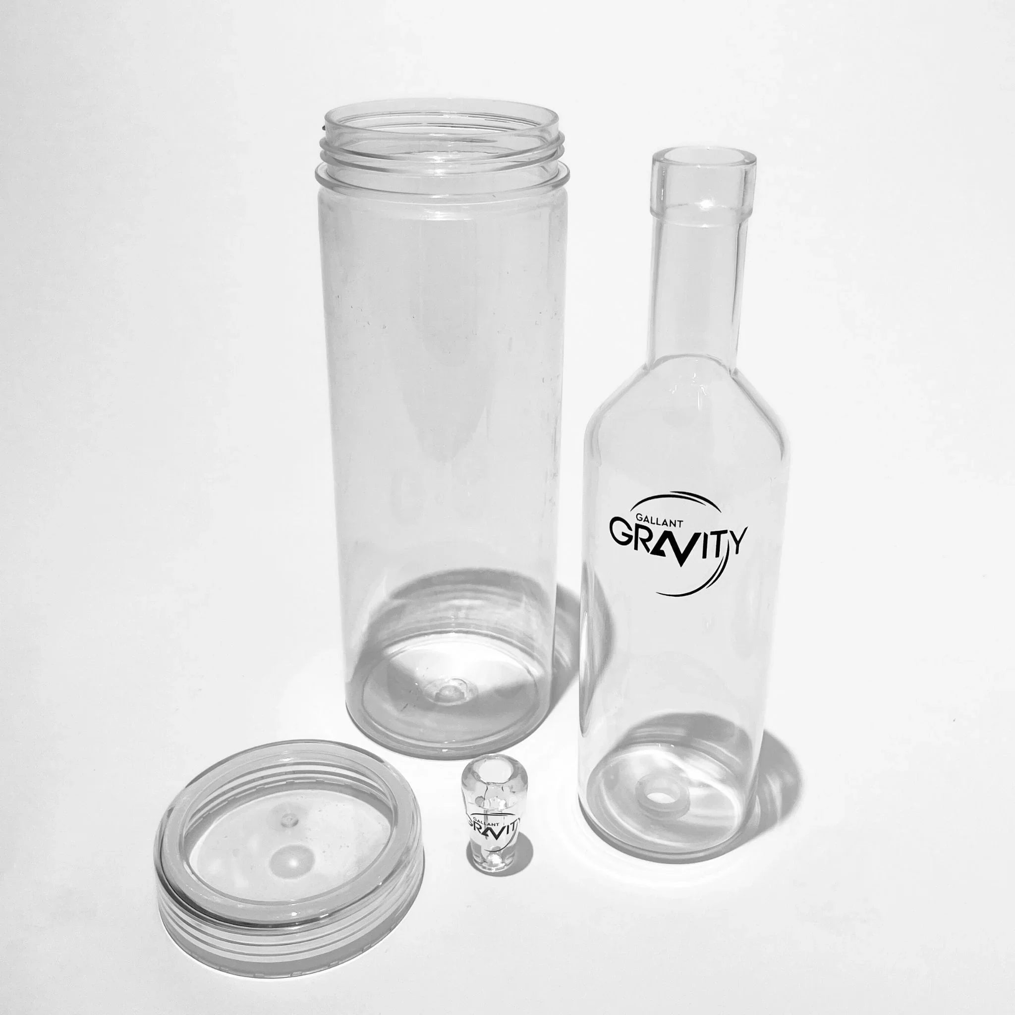 Clear glass gravity bong parts set on white background, modern gravity bong components