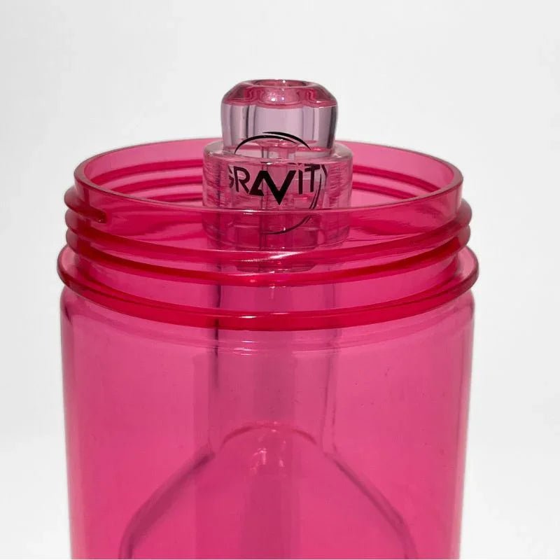 Translucent pink glass gravity bong base with clear glass bowl insert, modern design