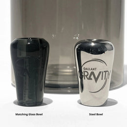 Matching glass bowl and steel bowl for gravity bong, shown side by side on white background.