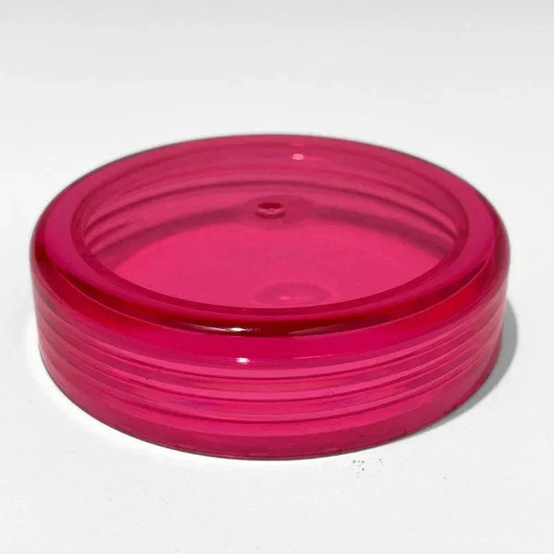 Pink transparent plastic gravity bong cap with threaded edges on a white background