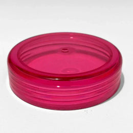 Pink transparent plastic gravity bong cap with threaded edges on a white background