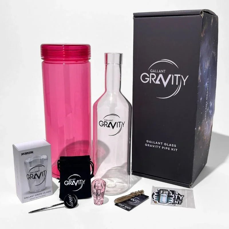 Glass gravity bong kit with pink bottle, clear glass chamber, accessories, and branded box.