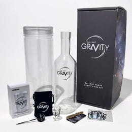 Glass gravity bong kit with bottle, cylinder, accessories, and branded packaging