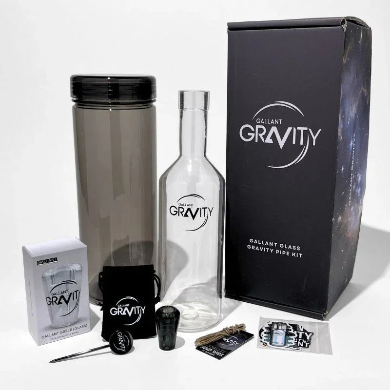Glass gravity bong kit with bottle, accessories, and packaging for dry herb use
