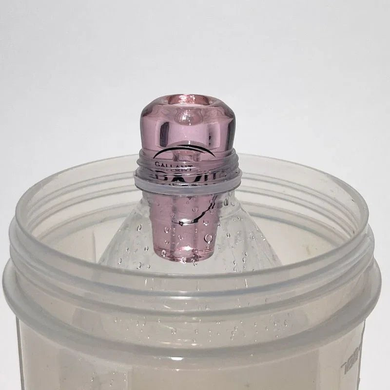 pink glass greeb in bottle